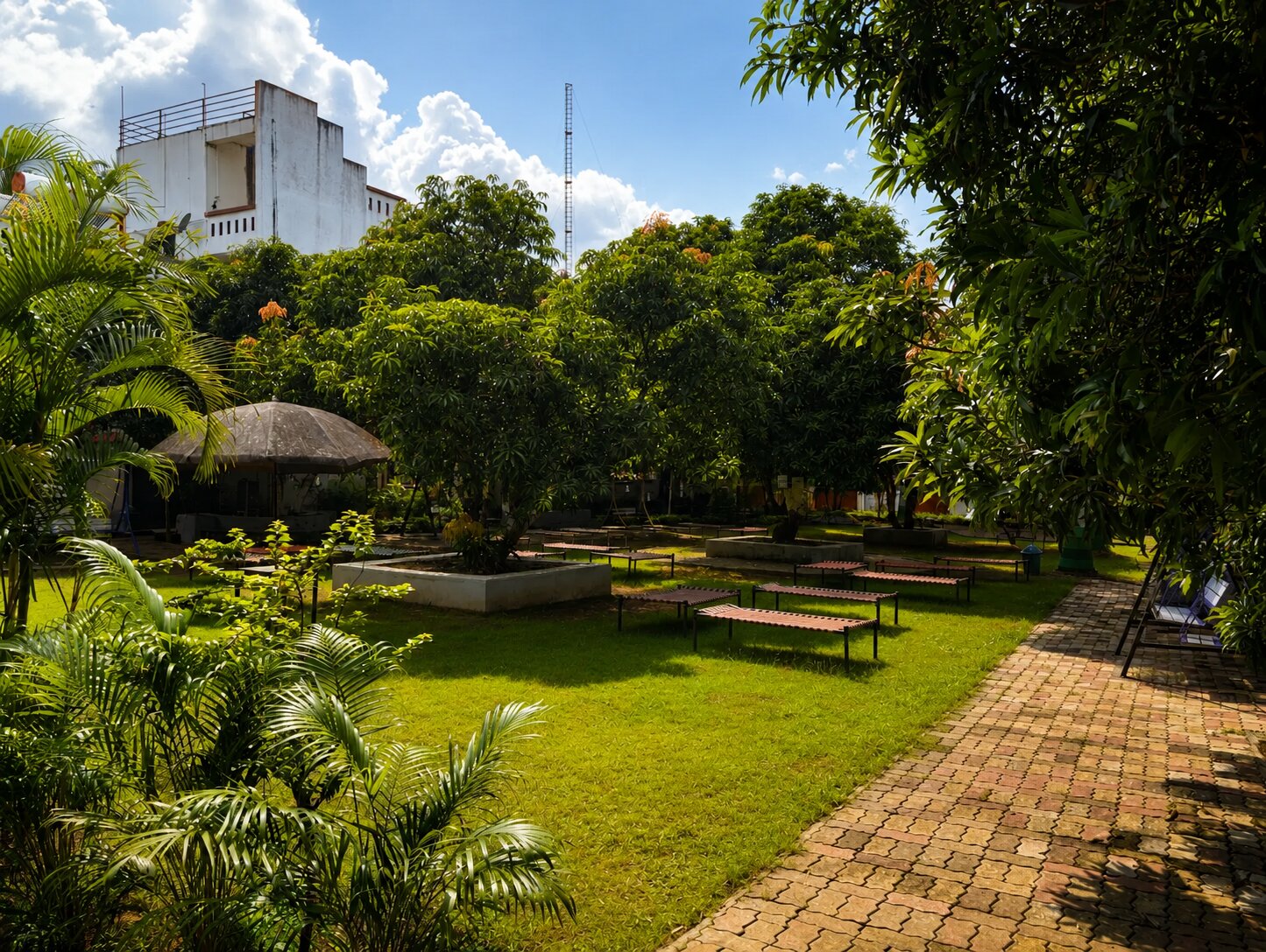Garden pathway and lawns at Wildlife Gir Resort